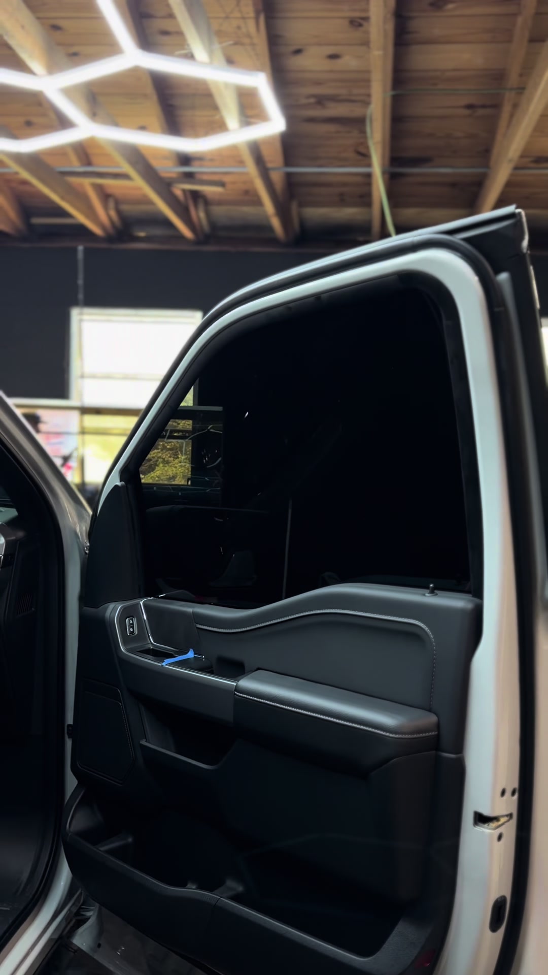 Blacked-out truck under the shop lights